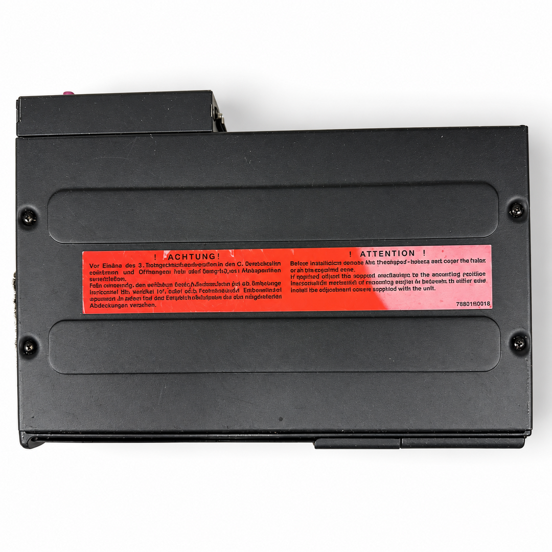 Used BMW 82111469404 six-disc CD changer - top panel and transport warning label