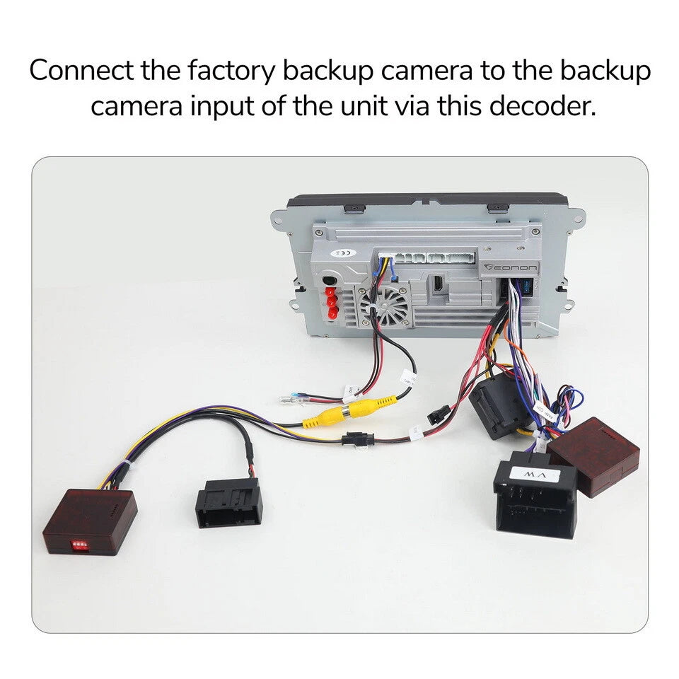 Black A501 rearview backup camera decoder box with yellow input port, surrounded by multiple black and white cables.