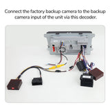 Black A501 rearview backup camera decoder box with yellow input port, surrounded by multiple black and white cables.